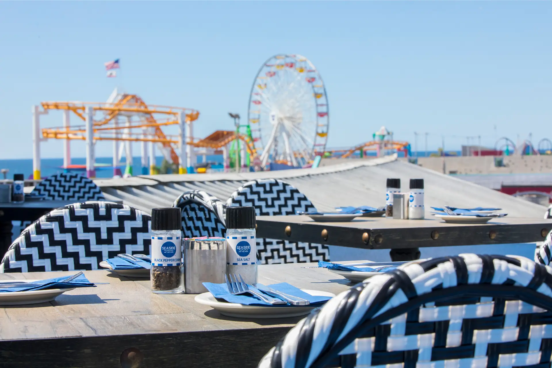 Seaside on the Pier Rooftop Table with Roller Coaster and Ferris Wheel in the background